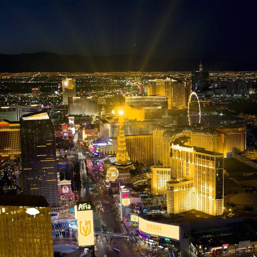 Aerial view of the Strip in Las Vegas with buildings covered in gold lighting